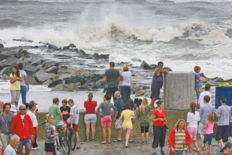 During high tide, a crowd gathers at the point in Longport to view the effects of the once-mighty Hurricane Earl. The peak gust in Atlantic City was 40 m.p.h., as the storm passed 200 miles off the coast. (Akira Suwa / Staff Photographer)