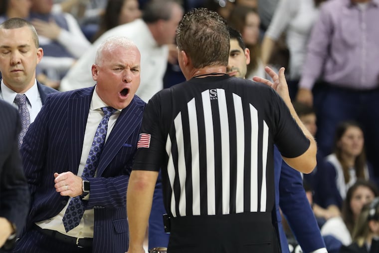 Pat Chambers (left) arguing with a referee during Penn State's game against Iowa at the Palestra on Jan. 4.