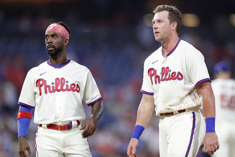 Phillies left fielder Andrew McCutchen (left) likely will return from the injured list Wednesday. But first baseman Rhys Hoskins (right) will be out until at least next week.