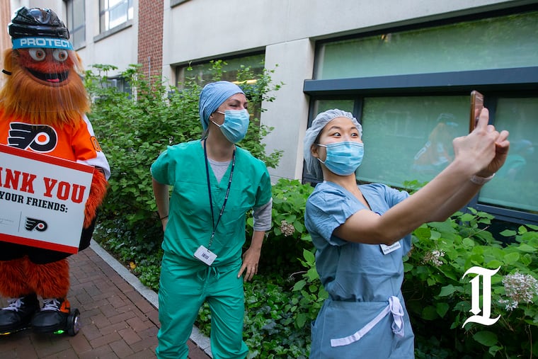 Gritty led cheers for frontline responders as they made a shift change at Hospital of the University of Pennsylvania on May 12, 2020. On Monday night, he will cheer on Penn Medicine health-care workers who will provide vaccines to any interested fan before and during the game against the New Jersey Devils.