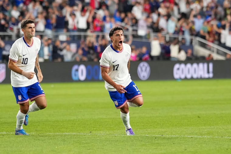 Alejandro Zendejas (center) celebrates with Christian Pulisic (left) after scoring the United States' opening goal.