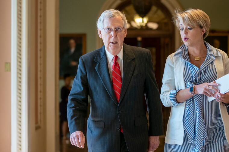 Senate Majority Leader Mitch McConnell (R., Ky.), with aide Stefanie Hagar Muchow, walks to his office to continue bipartisan budget discussions with top congressional leaders, Treasury Secretary Steven Mnuchin, and President Donald Trump's acting chief of staff Mick Mulvaney, at the Capitol in Washington, Tuesday, May 21, 2019.