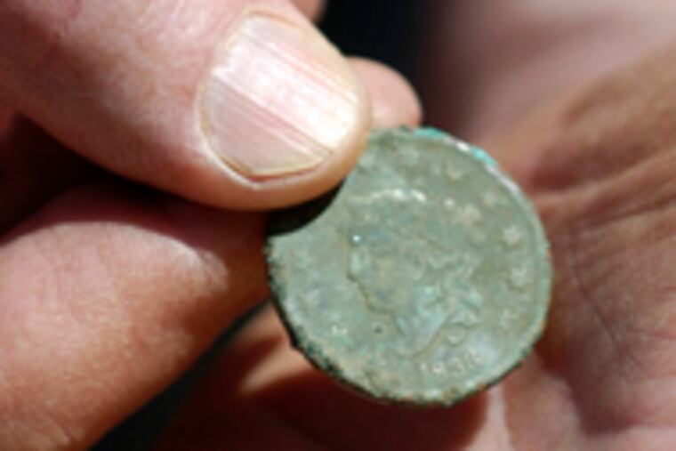 The 1833 penny that was found at the site.