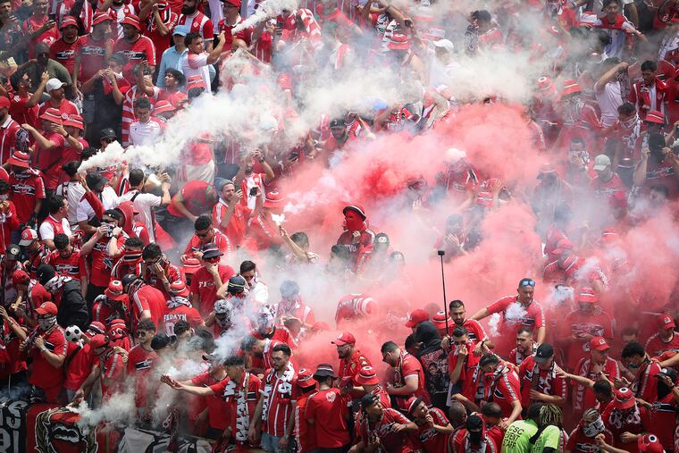 Red and white smoke floats over the Wydad fan section in the second half as they play Manchester City in a Club World Cup Group G match at Lincoln Financial Field in Philadelphia on Wednesday, June 18, 2025.
