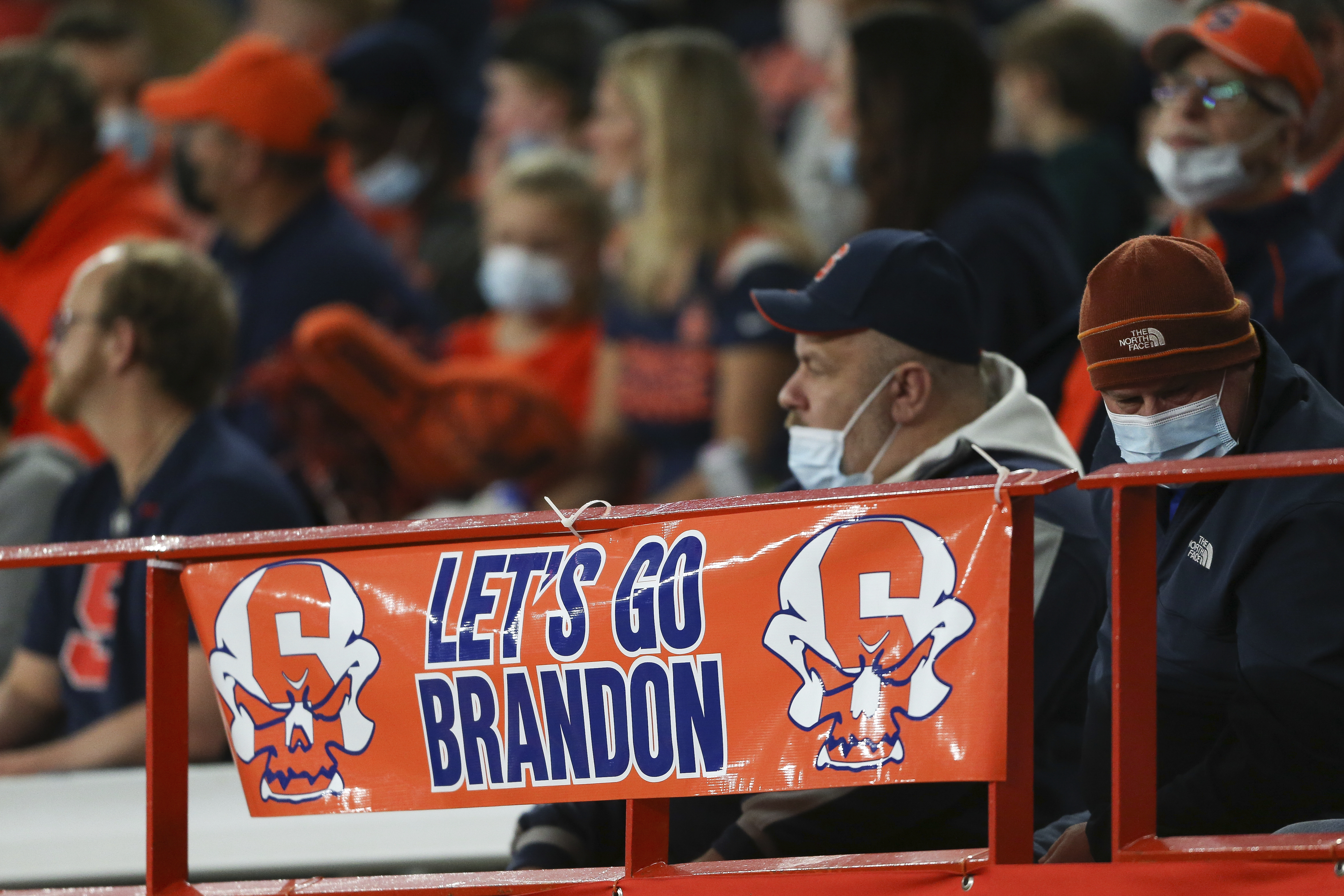 A sign reading "Let's go Brandon" is displayed on the railing in the first half of an NCAA college football game between Boston College and Syracuse in Syracuse, N.Y., Saturday, Oct. 30, 2021. Critics of President Joe Biden have come up with the cryptic new phrase to insult the Democratic president.