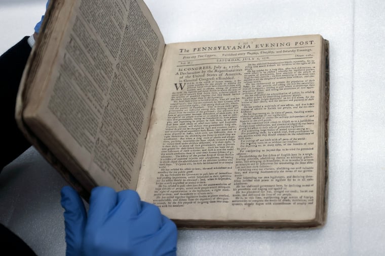 Museum of the American Revolution senior curator Matthew Skic opens a bound collection of the Pennsylvania Evening Post from 1776. It contained the first newspaper printing of the Declaration of Independence.