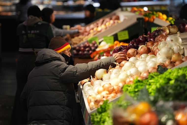 Customers shop at the Reading Terminal Market in Philadelphia in October. Grocery prices are up 28% since the pandemic.