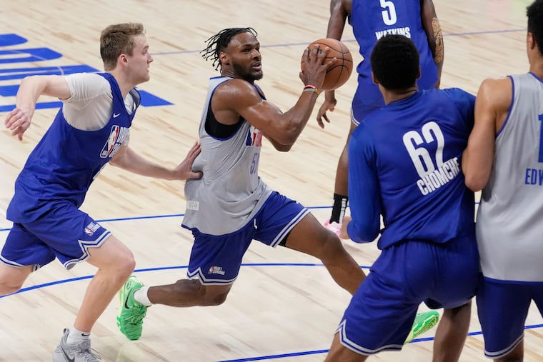Bronny James drives to the basket past Cam Spencer (left) at the NBA Draft Combine on Tuesday in Chicago.