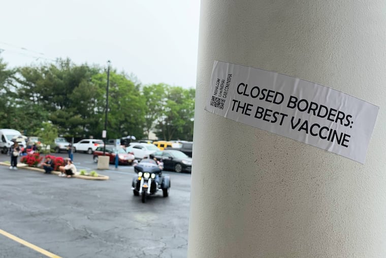 A sticker advertising the New Jersey European Heritage Association, a white-supremacist group, is on a pole outside the Atilis Gym in Bellmawr, N.J., which reopened despite government-ordered shutdowns.