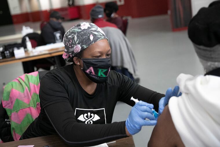 Dr. Faith Peterson administers a COVID-19 vaccine to a patient inside the Liacouras Center on Tuesday. The Black Doctors COVID-19 Consortium has been vaccinating Philadelphia residents.