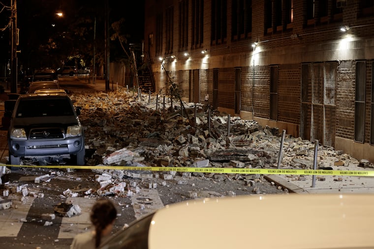Debris covers North 17th Street in Philadelphia after a building's partial collapse Sunday night. No injuries were reported.