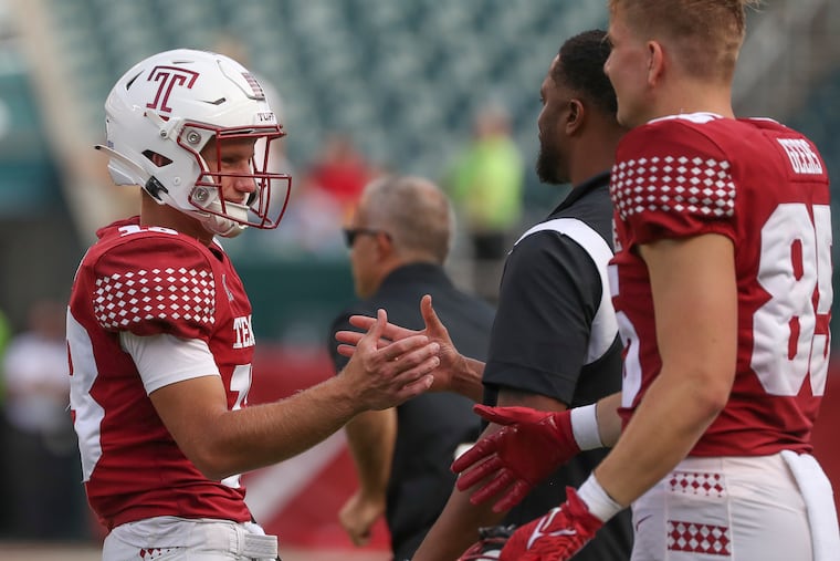 Temple Owls quarterback E.J. Warner shakes hands with coaches and teammates after a win over the Lafayette Leopards at Lincoln Financial Field.