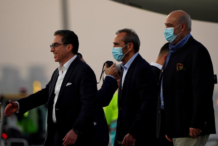 From left, Siamak Namazi, Emad Sharghi and Morad Tahbaz walk away from a Qatar Airways flight that brought them out of Tehran and to Doha, Qatar. Five prisoners sought by the U.S. in a swap with Iran were freed Monday and headed home as part of a deal that saw nearly $6 billion in Iranian assets unfrozen.