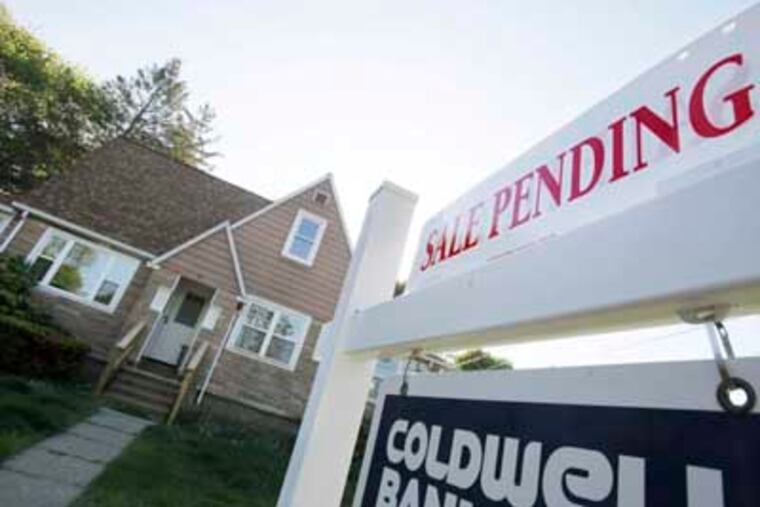 A sign advertises a pending residential real estate sale in Framingham, Mass., Thursday, April 26, 2012. The National Association of Realtors said the number of Americans who signed contracts to buy U.S. homes rose in March, the latest sign the battered housing market is slowly improving. (AP Photo/Bill Sikes)