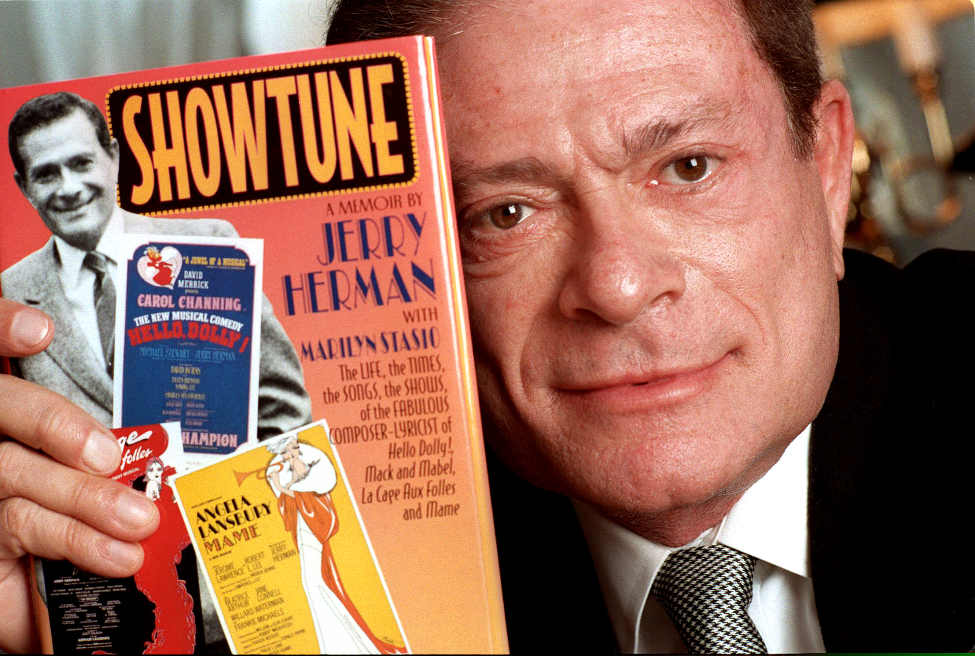 FILE - In this Nov. 19, 1996, file photo, composer Jerry Herman displays his book "Showtune," in New York. Herman, the Tony Award-winning composer behind "Hello, Dolly!" and "La Cage aux Folles," has died at age 88.