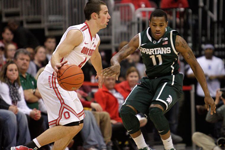 Ohio State's Aaron Craft looks for an open pass as Michigan State's Keith Appling defends during the second half. (Jay LaPrete/AP)