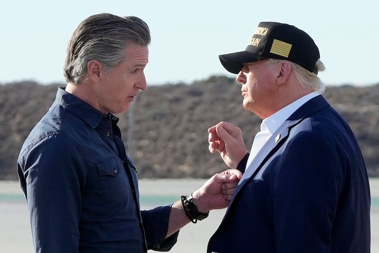 President Donald Trump talks with California Gov. Gavin Newsom after arriving on Air Force One at Los Angeles International Airport in Los Angeles on Friday.