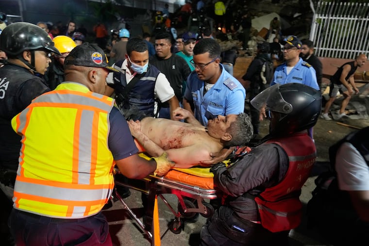 Rescue worker carry an injured man after an earthquake in Caracas, Venezuela, Wednesday, June 24, 2026.
