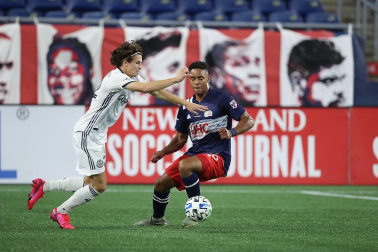 Brenden Aaronson, left, battles for the ball during the Philadelphia Union's game vs. the New England Revolution at Gillette Stadium in Foxborough, Massachussetts on July 20, 2020.