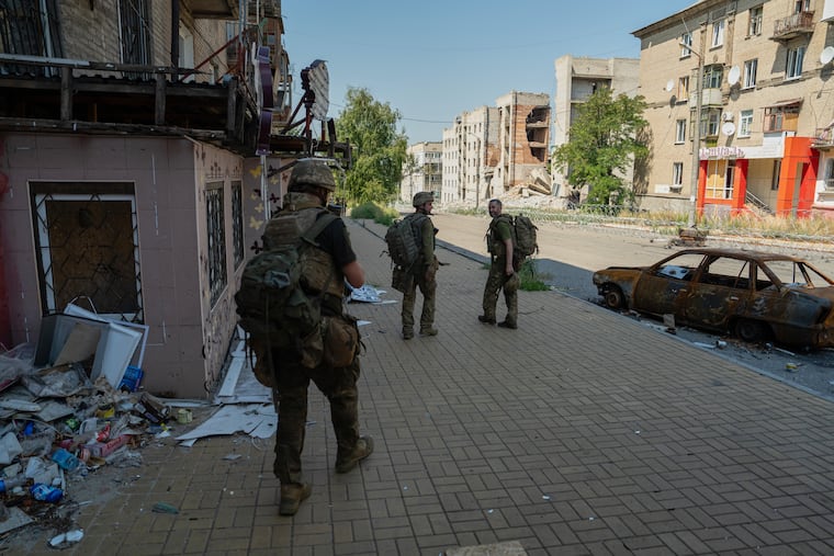 In this photo provided by Ukraine's 93rd Kholodnyi Yar Separate Mechanized Brigade press service and taken Monday, Aug. 10, 2026, Ukrainian soldiers walk along the street in the frontline town of Druzhkivka, Donetsk region, Ukraine.