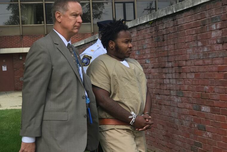 Authorities escort Izena Goudy, now 35, of Brooklyn, to a police car outside the Delaware County Courthouse in September 2017.