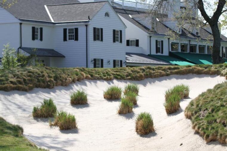 A very large bunker with patches of grass on the left fairway close to the 18th green. (Michael Bryant/Staff Photographer)