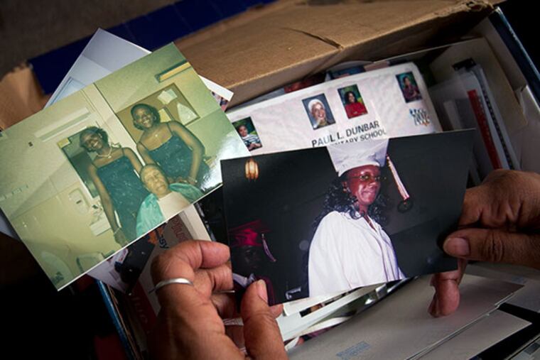 Asenath Brown, mother of Monea Palmer holds a high school graduation photograph of her daughter Monae Palmer. Monae a young pregnant woman injured by a hit and run driver as she on her way to CHOP nearly a week ago. Photograph of her mother in her home on the 800 block of N. 13th St. on Wednesday morning October 16, 2013. ( ALEJANDRO A. ALVAREZ / STAFF PHOTOGRAPHER )