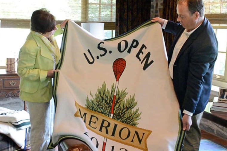 Janis and Tony McBryan - who had been laid off and was in a bad way when he made his call to Merion - display the blanket featuring the U.S. Open logo. (Tom Gralish / Staff Photographer)