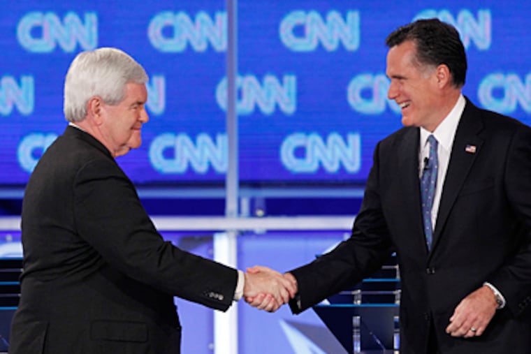 Republican front-runners Newt Gingrich (left) and Mitt Romney shake hands at the start of Thursday night's debate in Florida. (Matt Rourke / Associated Press)