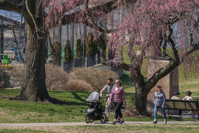 Joe and Lauren Leopanto walk with their son and Joe’s mother Sandy Leopanto, back right, behind the Art Museum last month.