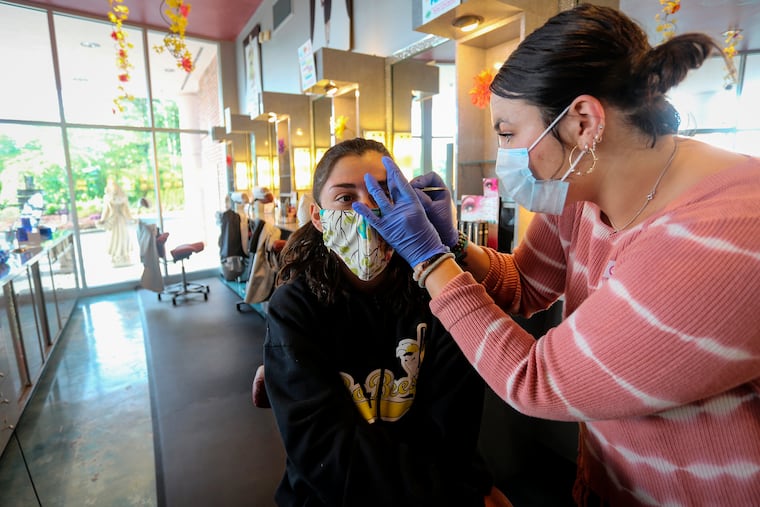 A customer gets her eyebrows waxed at Three-13 Salon, Spa & Boutique in Marietta, Georgia.