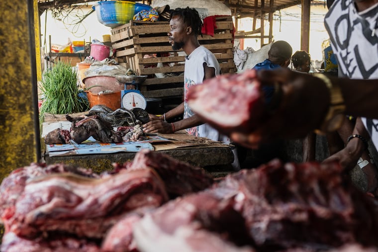 Guyva Mputu, a vendor at the Masina market, displays bushmeat for sale in Kinshasa, Congo, Thursday, April 9, 2026.
