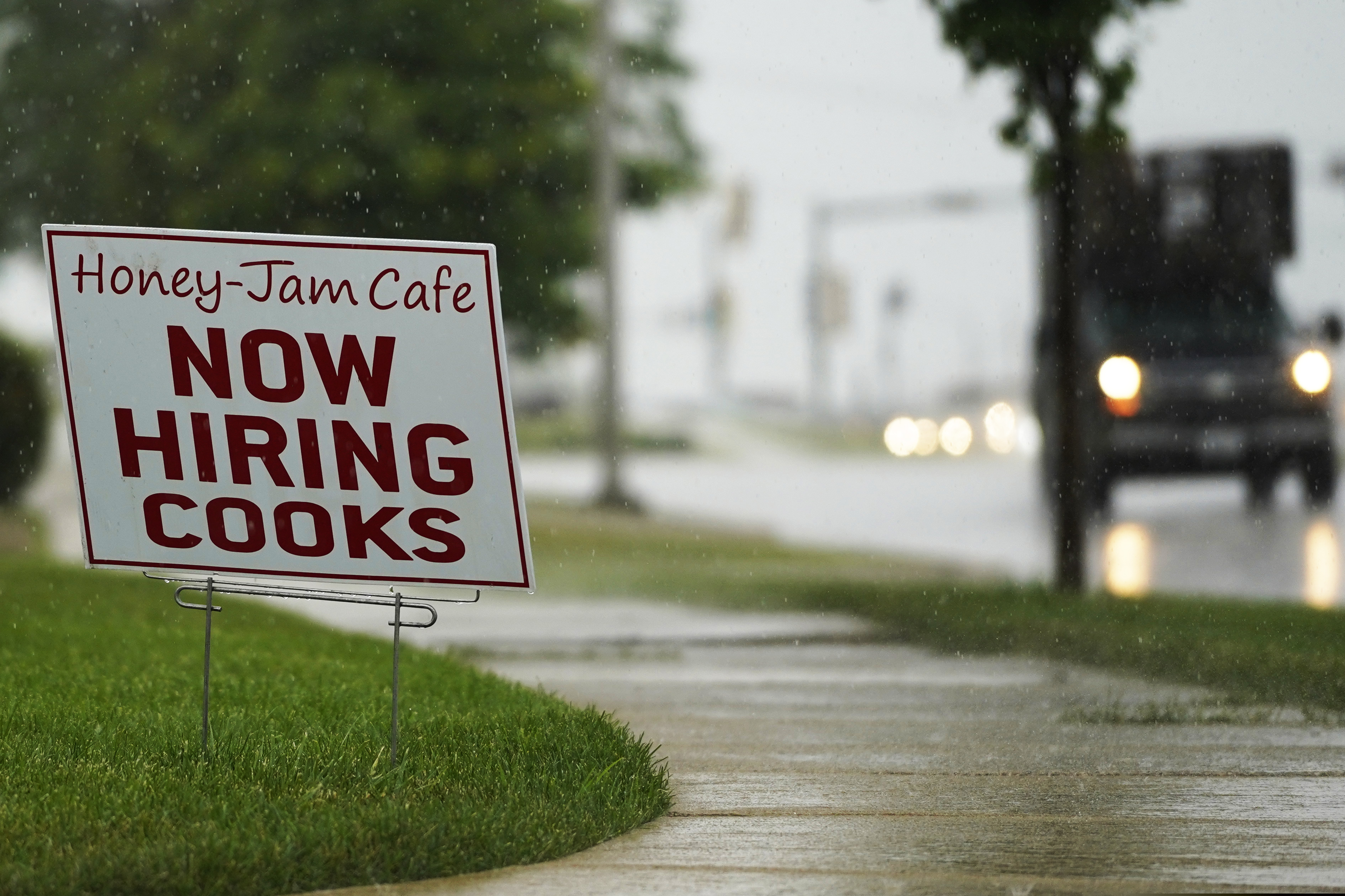 A hiring sign is shown in Downers Grove, Ill.