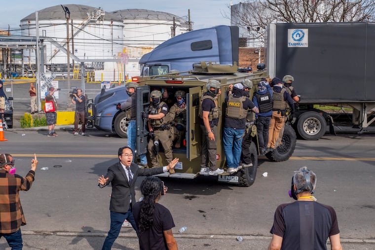 U.S. Sen. Andy Kim (D., N.J.) (center left) attempts to de-escalate tensions between protesters and ICE agents outside Delaney Hall in Newark, N.J., as a hunger strike by immigration detainees there entered its fourth day on Monday.