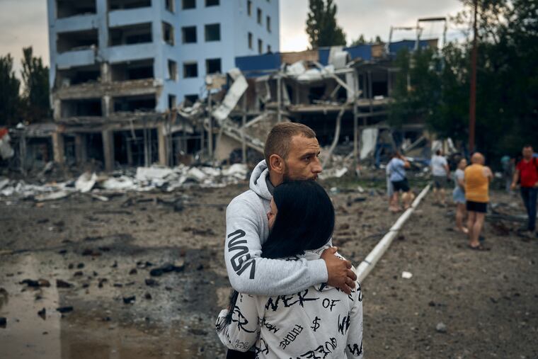 A couple reacts after the Russian shelling in Mykolaiv, Ukraine, on Wednesday.