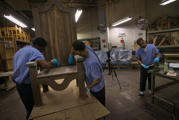 From left, Rameen Perrin, Evan Davis and Hakiem Burke work on a chair that will be presented to Pope Francis as a gift during the pope's visit to the Philadelphia Industrial Correctional Center. ( ALEJANDRO A. ALVAREZ / Staff Photographer )
