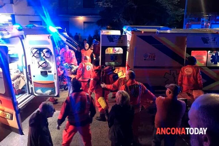 Rescuers assist injured people outside a nightclub in Corinaldo, central Italy, early Saturday, Dec. 8, 2018. At least six people, all but one of them minors, were killed and about 35 others injured in a stampede of panicked concertgoers early Saturday at a disco in a small town on Italy's central Adriatic coast. (Stefano Pagliarini/Ancona Today via AP)