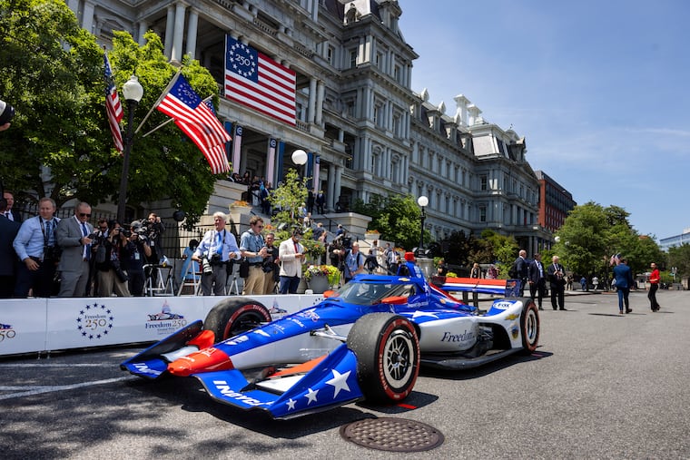 Members of an IndyCar pit crew demonstrate a tire change near the White House and the Eisenhower Executive Office Building in July.