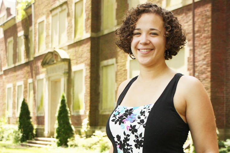 Hannah Karena Jones stands in front of a former medical building at Byberry State Hospital, the subject of her new book.