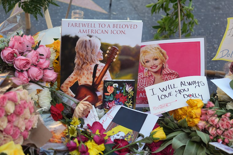 Flowers, notes and photos are left on Dolly Parton's star on the Hollywood Walk of Fame on Wednesday, Aug. 26, 2026, in Los Angeles. (AP Photo/Jae C. Hong)