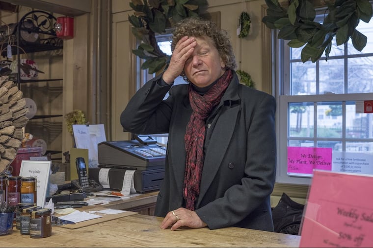Susan LeBoutillier , owner of LeBeau Gardens, a Downingtown landscape design company. LeBoutillier depends on legal, seasonal workers from Mexico to make her business viable. Here she stands behind the sales counter in her shop.