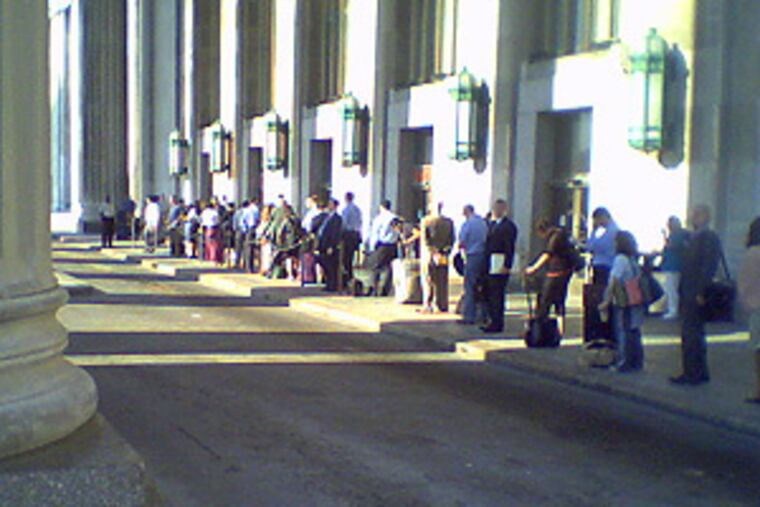 Commuters and visitors wait for cabs at 30th Street Station. As trains arrived, long lines would form, then steadily shorten, as people found rides with non-striking taxis and limousines.