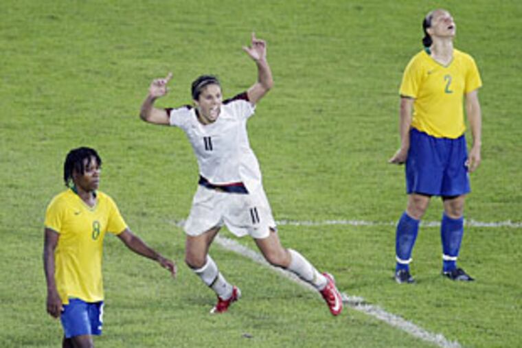 Carli Lloyd of Delran celebrates her goal in overtime of the Olympic gold medal game as Brazil's Simone (2) and Brazil's Formiga react.