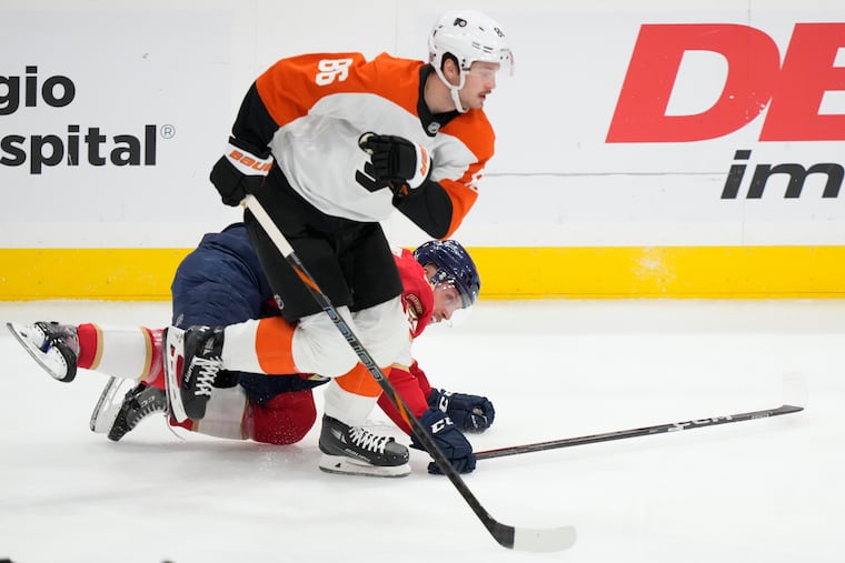 Philadelphia Flyers left wing Joel Farabee (86) and Florida Panthers defenseman Nate Schmidt, rear, battle for the puck during the first period of an NHL hockey game, Saturday, Nov. 9, 2024, in Sunrise, Fla. (AP Photo/Wilfredo Lee)