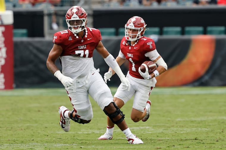 Temple offensive tackle Giakoby Hills (left) shown with teammate Colin Chase against on Sept. 6.