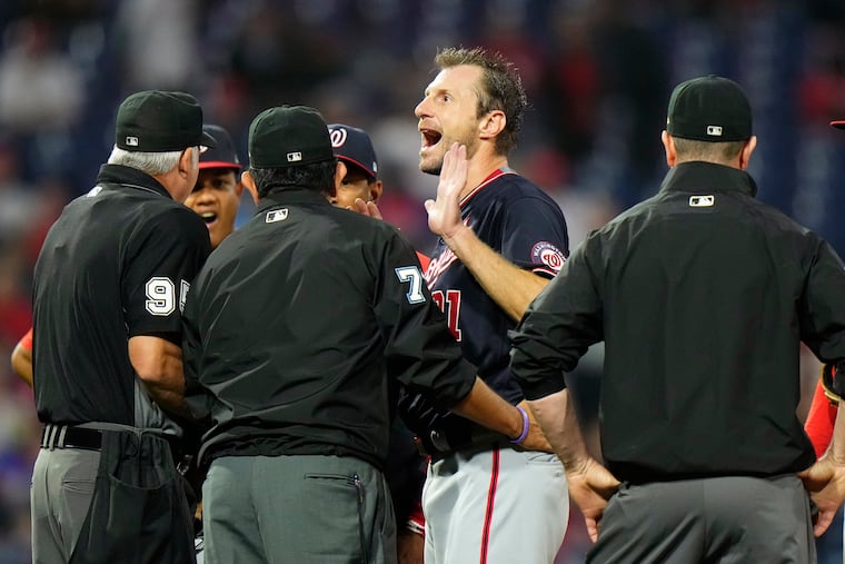 Washington Nationals pitcher Max Scherzer reacts as he talks with umpires during a foreign-substances check in the fourth inning.