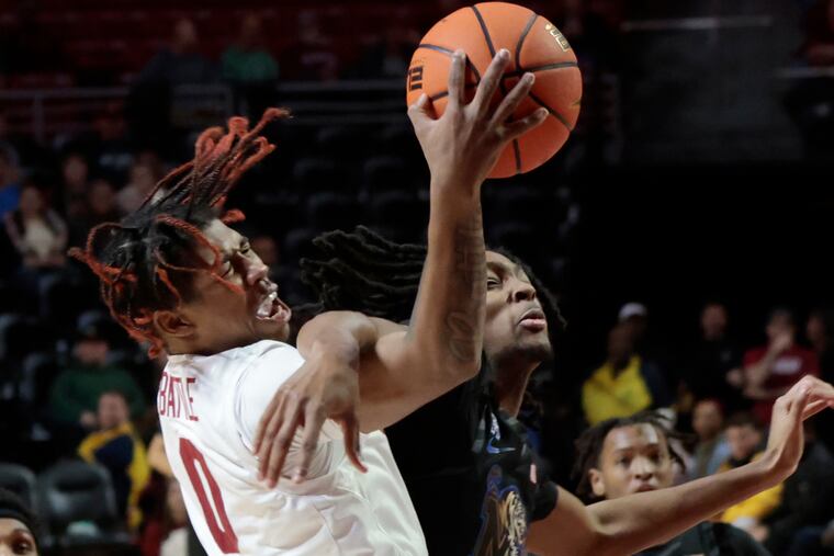 Temple # 0 Khalif Battle is fouled by Memphis # 11 Johnathan Lawson in the first half of the Memphis at Temple University mens basketball game at Temple’s Liacouras Center in Phila., Pa. on Sun., Jan. 15, 2023. Battle was cut under his eye and Lawson was called for a flagrant foul on the play. Memphis hit a basket at the buzzer giving them a 61-59 victory.