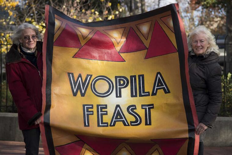Artist Lou Ann Merkle (left) and former Philadelphia restaurateur Judy Wicks with Merkle’s banner they will be taking to the Standing Rock Sioux Reservation in North Dakota in support of those protesting a pipeline (“Wopila” means “Thanks” in Lakota Sioux). Wicks has arranged donations to feed 2000 people at a Thanksgiving dinner.