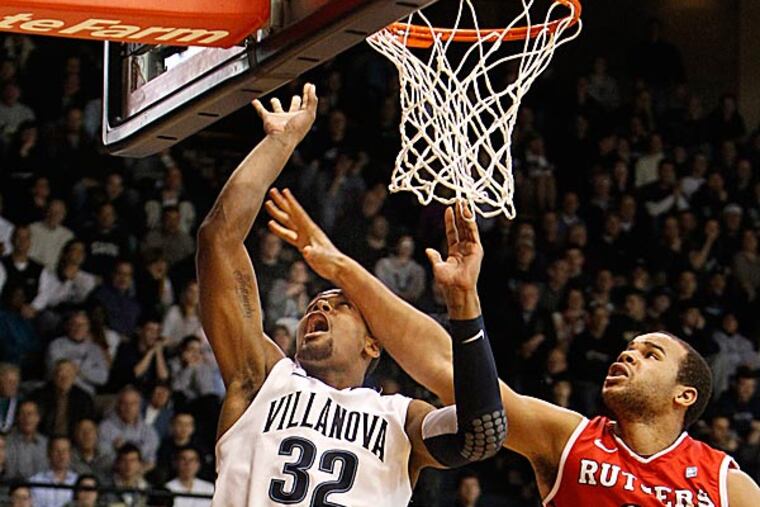 Villanova's James Bell scores despite the pressure from Rutgers' Austin Johnson. (Ron Cortes/Staff Photographer)