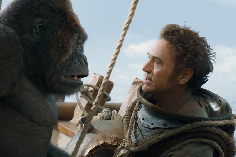 In the movie "Dolittle," Dr. John Dolittle (Robert Downey Jr., right) can talk to animals, including Chee-Chee the gorilla (voice of Rami Malek).